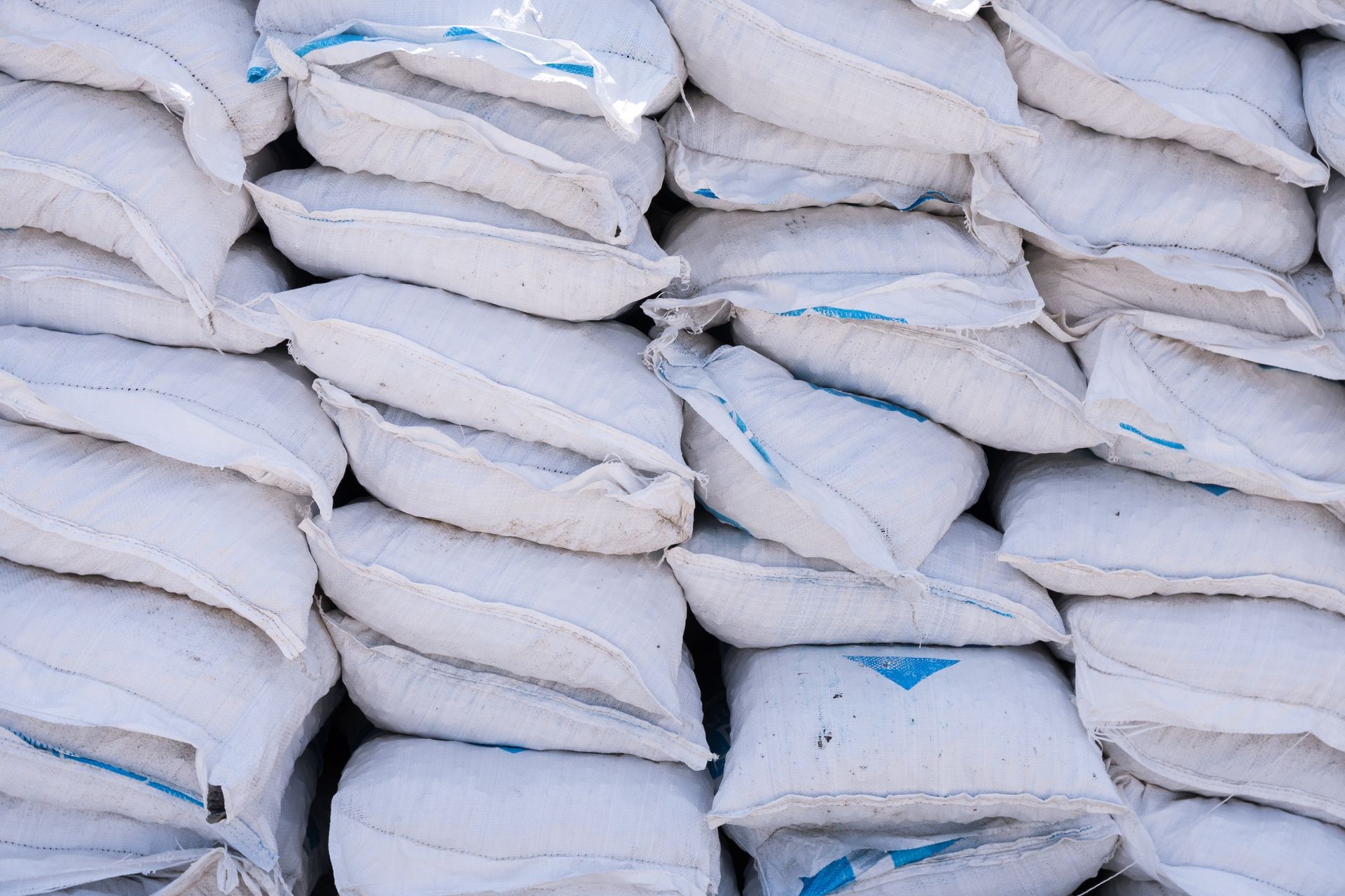 Stacks of cement bags, closeup. Outdoors on  construction site